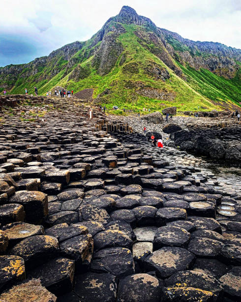 Giant Causeway’s hexagon rock formations Hexagon rock formations of the Giant Causeway, a UNESCO World Heritage Site, of Northern Ireland, United Kingdom, on a gloomy, cloud day. giants causeway stock pictures, royalty-free photos & images