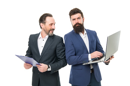 Being on agenda. Bearded men have working meeting. Having business meeting. Businessmen with laptop and clip board. Formal meeting. Meeting appointment. Holding workshop.