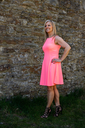 A blonde female in a summer dress