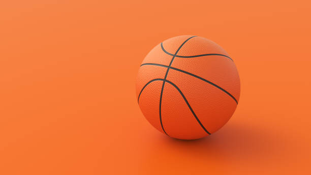 istock Basketball ball on orange background 1356635925