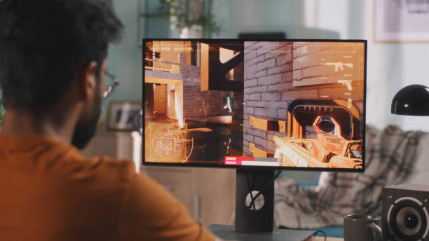 istock Indian gamer playing shooter at home 1356636000