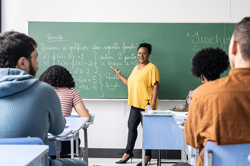 Teacher talking students during class at school