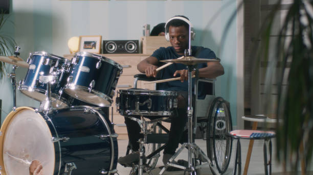 Black man on wheelchair playing drums