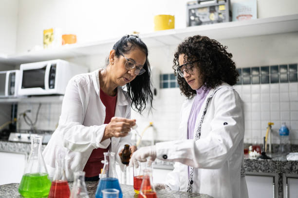 Teacher teaching a teenager student in the laboratory Teacher teaching a teenager student in the laboratory high school student classroom education student stock pictures, royalty-free photos & images