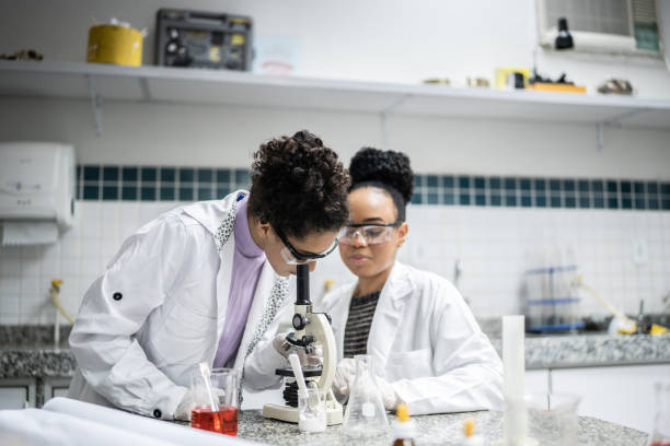 istock Teenage student using the microscope in the laboratory 1356638311