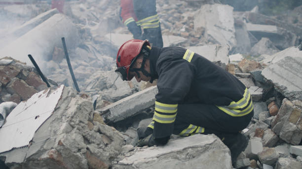 istock Male rescuers removing concrete rubble 1356638447