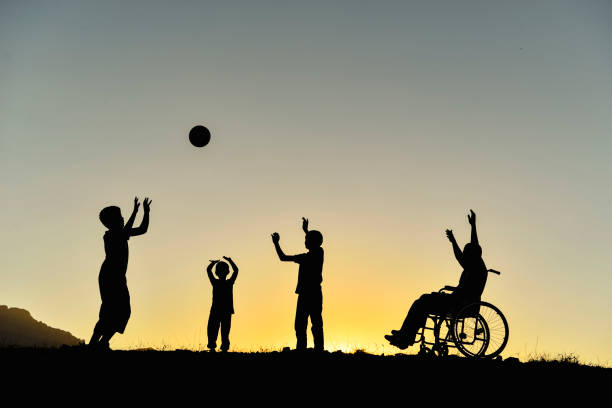 children with support for their friends with disabilities and a happy environment stock photo