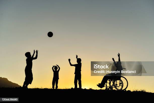 Children With Support For Their Friends With Disabilities And A Happy Environment Stock Photo - Download Image Now