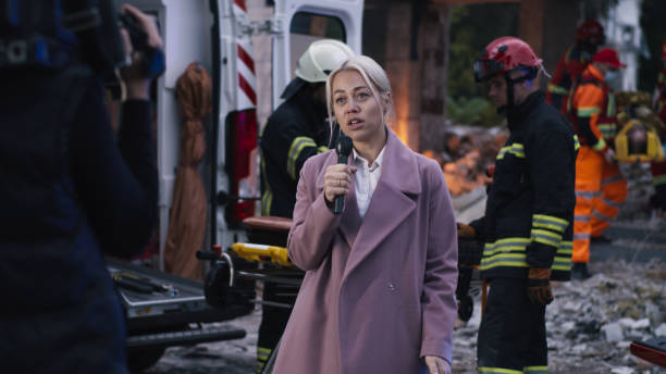 istock Female journalist reporting after disaster 1356639015