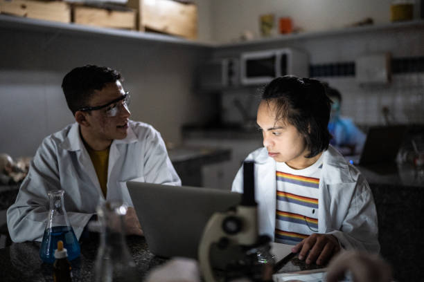 istock Students studying in a lab at school or university - including person with special needs 1356640072