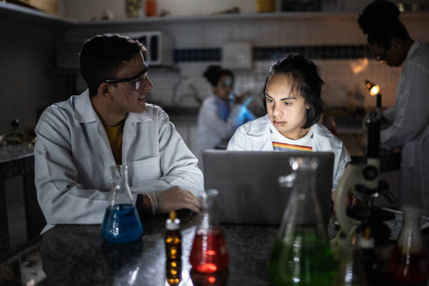 istock Students studying in a lab at school or university - including person with special needs 1356640180