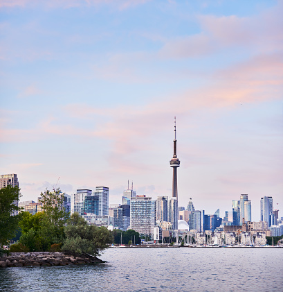 View of the CN Tower and the city of Toronto as seen from Lake Ontario at sunset in the summer