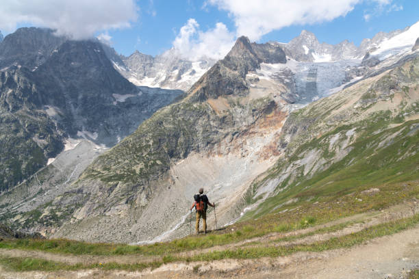 istock Hiker enjoying the view while hiking the Tour Du Mont Blanc 1356647956