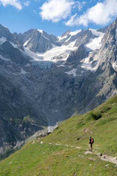 istock Hiker looking at huge mountains in the Italian Alps 1356647961