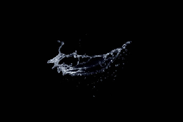 Water splash isolated on black background. stock photo