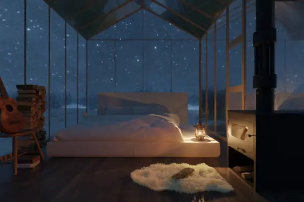 Photo of 3d rendering of cozy hut with bed and glass panels at snow covered forest