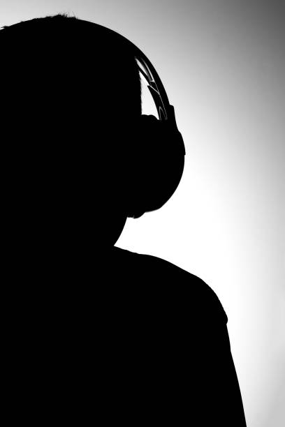 Silhouette of boy Black and white image silhouette of boy with headphones listening music black and white headphones stock pictures, royalty-free photos & images