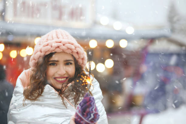 istock Cute lady having fun with sparklers 1356650407