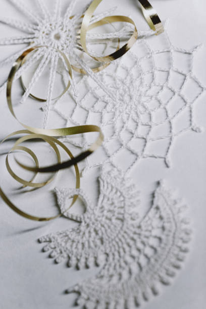 istock Christmas tree decorations, handmade snowflakes and angels, macrame-style weaving, handmade decor in eco-style, top view 1356651226