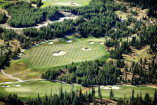 An aerial image of a Gold course at a mountain resort.