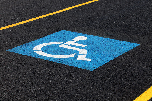 A sign marking a reserved handicapped parking space