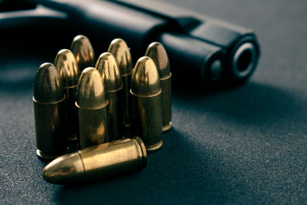 istock Gun, Pistol with ammunition on black  background 1356653467