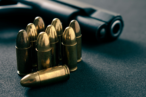 Gun, Pistol with ammunition on black  background