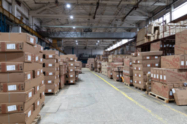 Cardboard boxes on conveyor belt at distribution warehouse