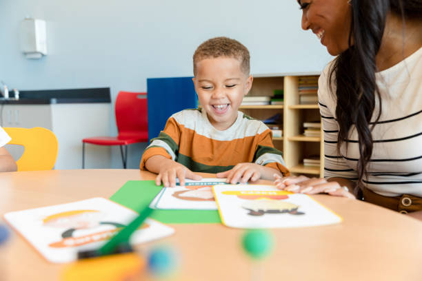istock Female teacher works with preschool boy 1356661365