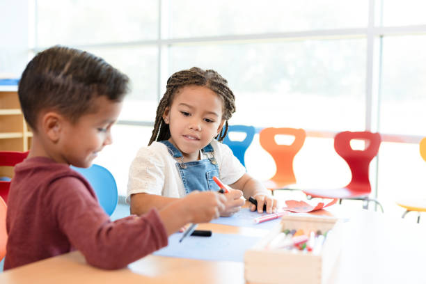 istock Preschool age boy shows friend drawing 1356661399