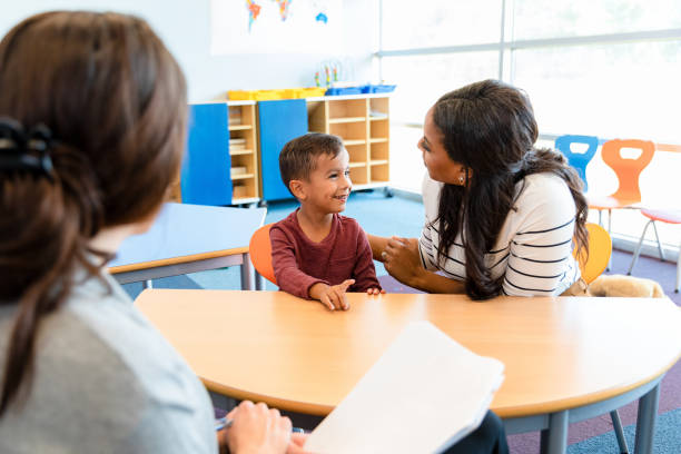 istock Little boy talks to mom during play therapy session 1356661519