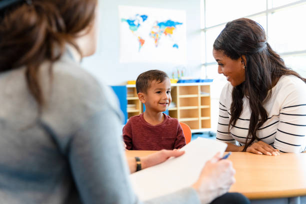 Child psychologist talks with young boy and his mom A child psychologist talks with a boy and his mom during a play therapy appointment. mental health professional stock pictures, royalty-free photos & images