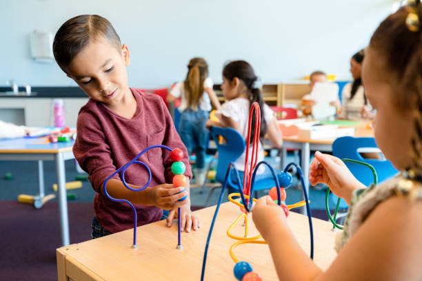 istock Cute little boy plays with bead maze toy 1356661569