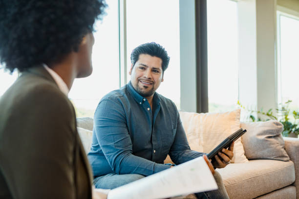 istock Businesspeople talk before meeting begins 1356661721