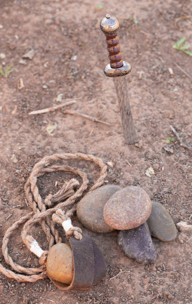 istock The Sling of David with Five Smooth Stones and Goliaths Sword in the Dirt 1356665721