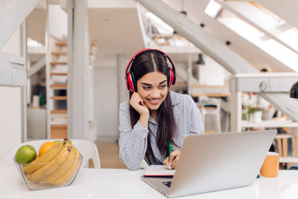 istock Happy girl working from home 1356668742