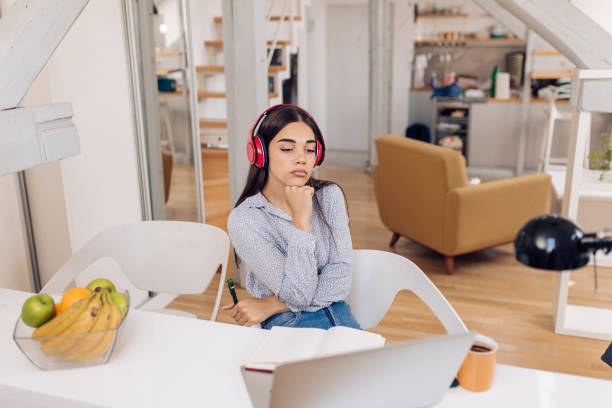 istock Young woman working online from her home office 1356668755