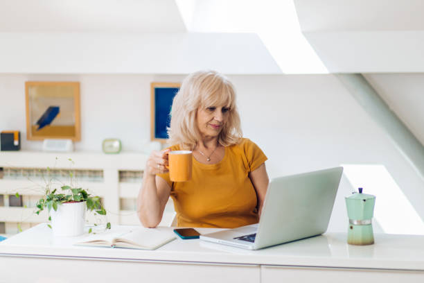 istock Mature entrepreneur working online at her home office 1356669234