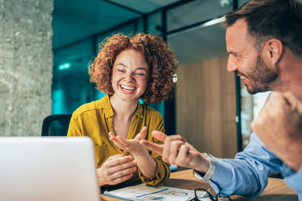 istock Two business people working together in office 1356670640