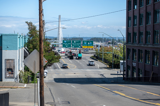 Tacoma, WA USA - circa August 2021: Uphill view of city traffic in downtown Tacoma near the interstate entrance ramp.