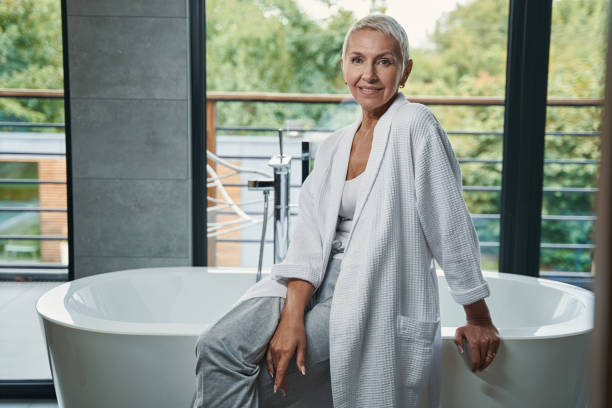 istock Positive delighted woman sitting on the bath 1356679646