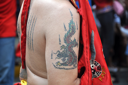 Jakarta, Indonesia - Februari 21, 2016 : A dragon tattoo on the upper arm of a monk at the Cap Go Meh event in Jakarta, Indonesia.