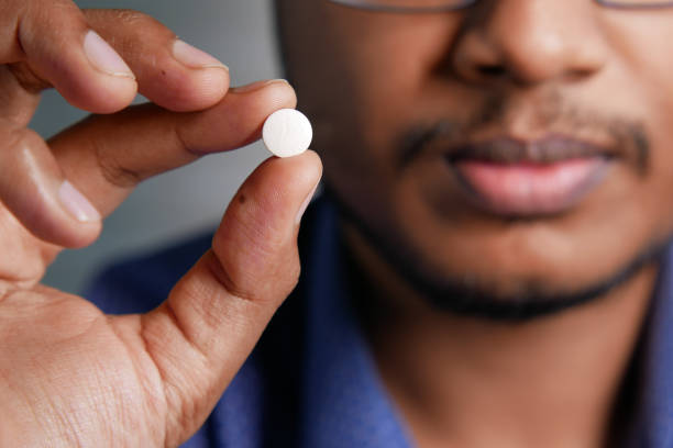 istock upset man hand holding medical pills 1356694345
