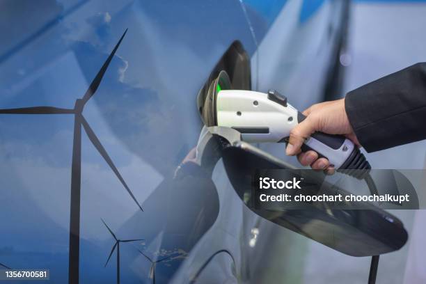 Double Exposure Of Ev Charging Station For Electric Car In Concept Of Green Sustainable Energy Produced From Renewable Resources To Supply To Charger Station In Order To Reduce Co2 Emission Stock Photo - Download Image Now