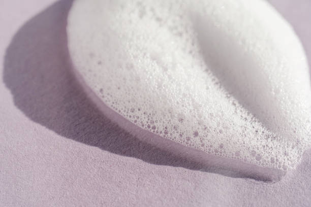 istock Texture of white foam on a purple background. 1356702819
