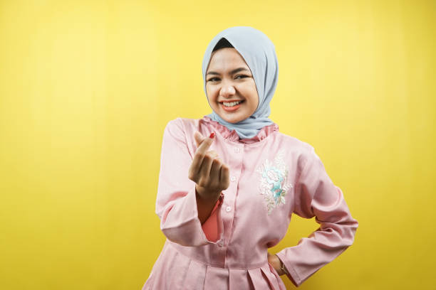 Beautiful young muslim woman with korean style love sign isolated stock photo