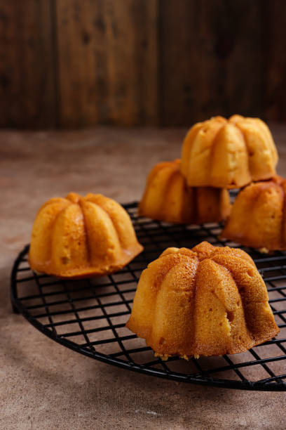 istock Kue lemon. Mini lemon bundt cakes topped with lemon glaze 1356703464