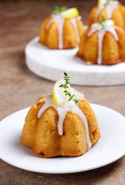 istock Kue lemon. Mini lemon bundt cakes topped with lemon glaze 1356703499