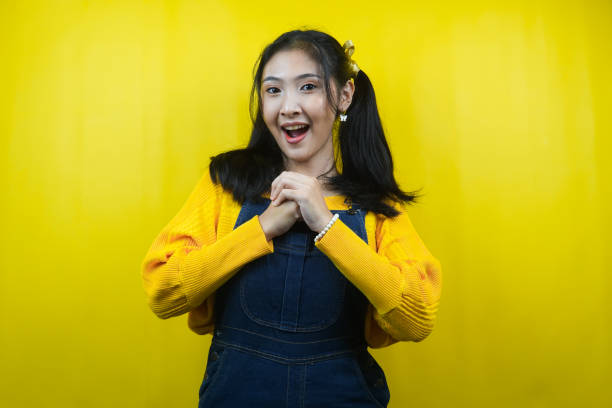 istock Pretty and cute young woman surprised, shocked, wow expression, presenting something, promoting a product, advertising, isolated 1356704394