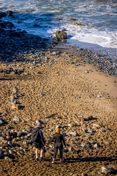 istock Young Couple Hiking Along Coast 1356705637